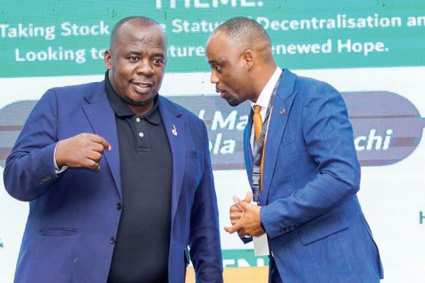 Malga executive director Hadrod Mkandawire confers with Chimwendo-Banda during the ceremony