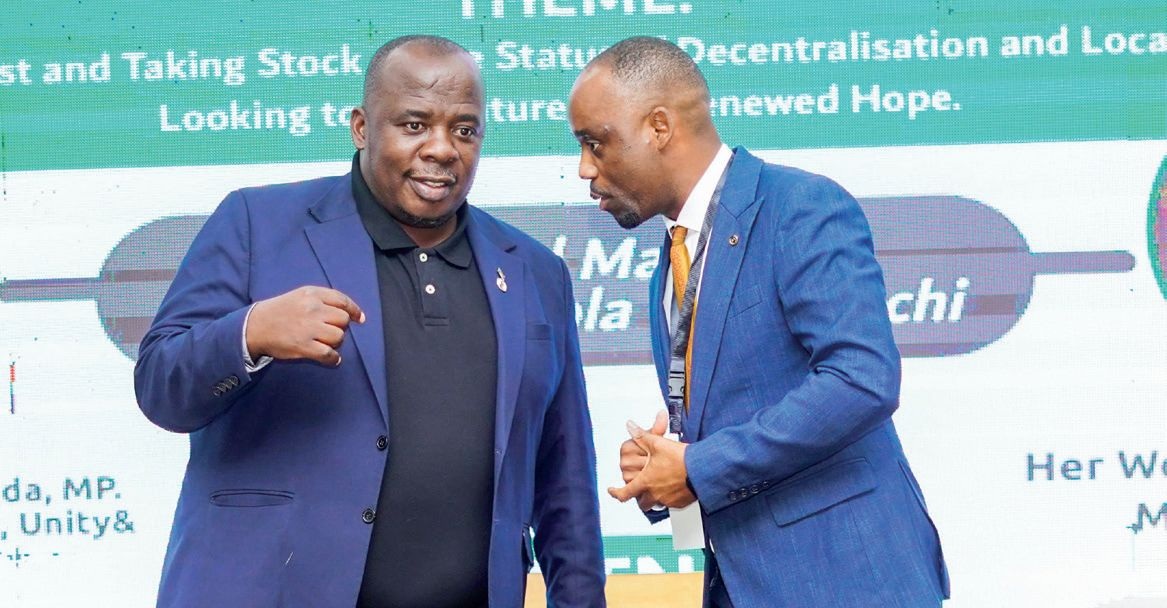 Malga executive director Hadrod Mkandawire confers with Chimwendo-Banda during the ceremony
